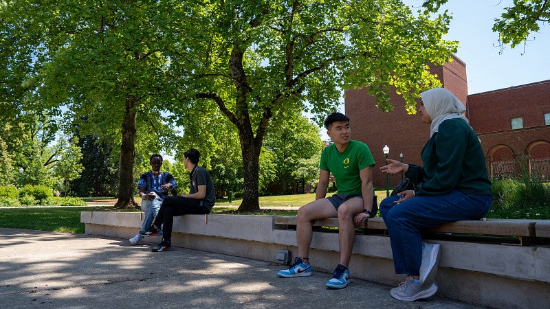 Students sitting outside and talking