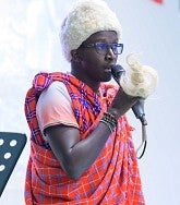 Student, Erick, speaking on a stage
